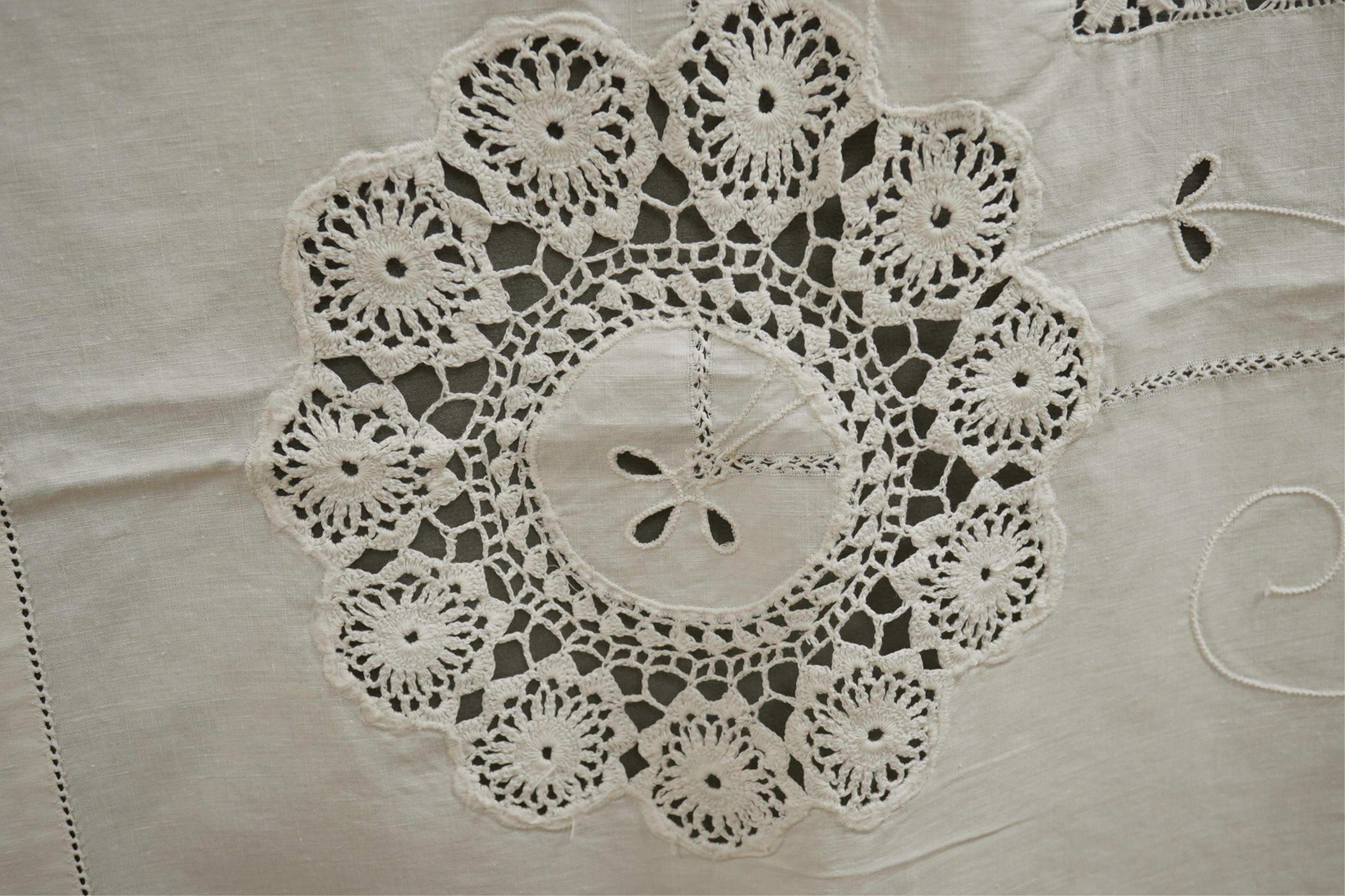 A collection of early 20th century and later crochet, cut work and drawn thread table linens and a large embroidered table cloth